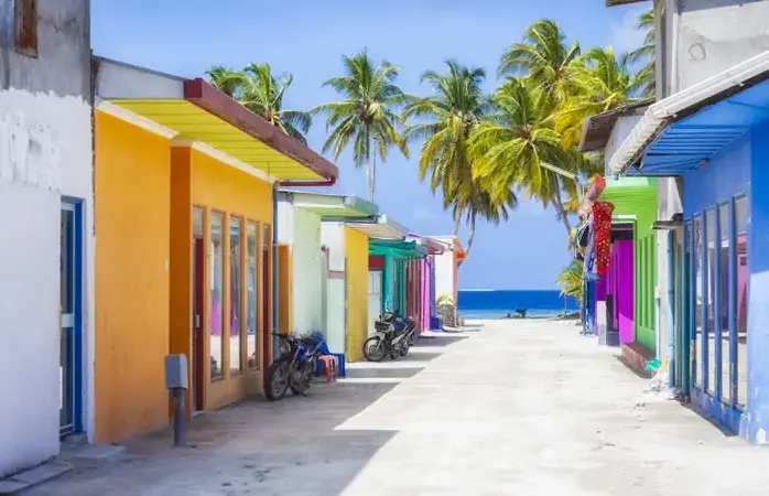 Shopping street with typically colorful house facades in Maafushi a local island in the Maldives.