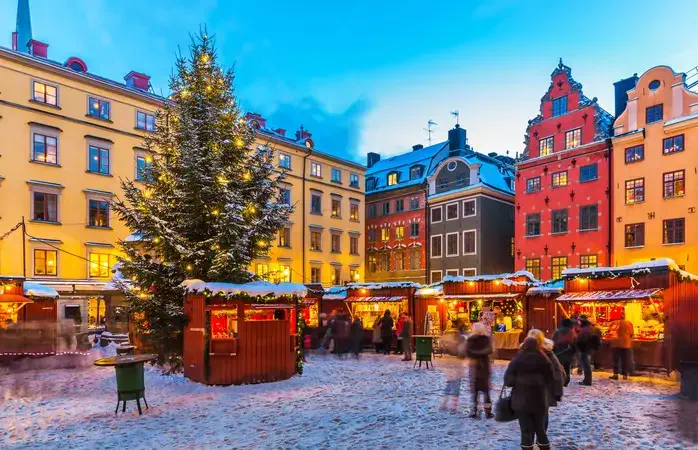 Beautiful snowy winter scenery of Christmas holiday fair at the Big Square (Stortorget) in the Old Town (Gamla Stan) in Stockholm, Sweden
